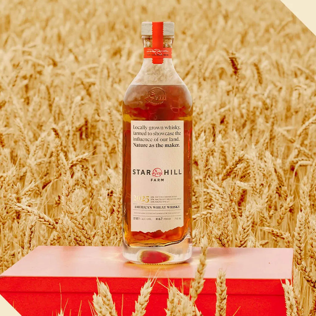 Maker's Mark Star Hill Farm American Wheat Whiskey bottle in a wheat field